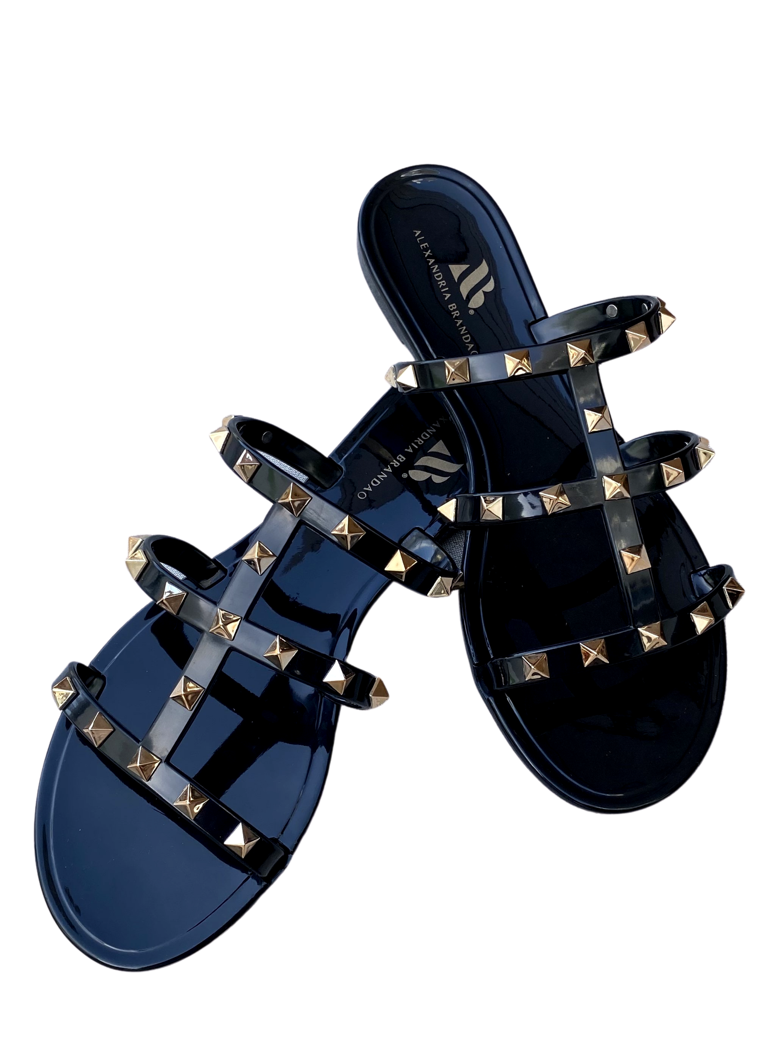 Aurora Black Jelly sandal that has  Gold Studs on all straps and is a slip on sandal.  Sandal has three equally separated horizontal straps that goes all the way to top of the bridge of the foot and one strap in the middle connecting all straps
