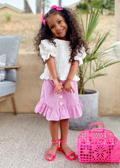 @honor_monroe wearing matching Girl kid's neon pink Aria jelly studded sandals studded with rigged strap in the front and on in the back around the ankle that buckles at ankle that matches women's neon pink jelly studded jelly waterproof Aria Sandals so that mom's and daughters can have matching shoes as their friendship bracelet by Alexandria Brandao Shoes.