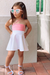 little girl wearing pink dress paired with shoes by Alexandria Brandao white strap girl sandals
