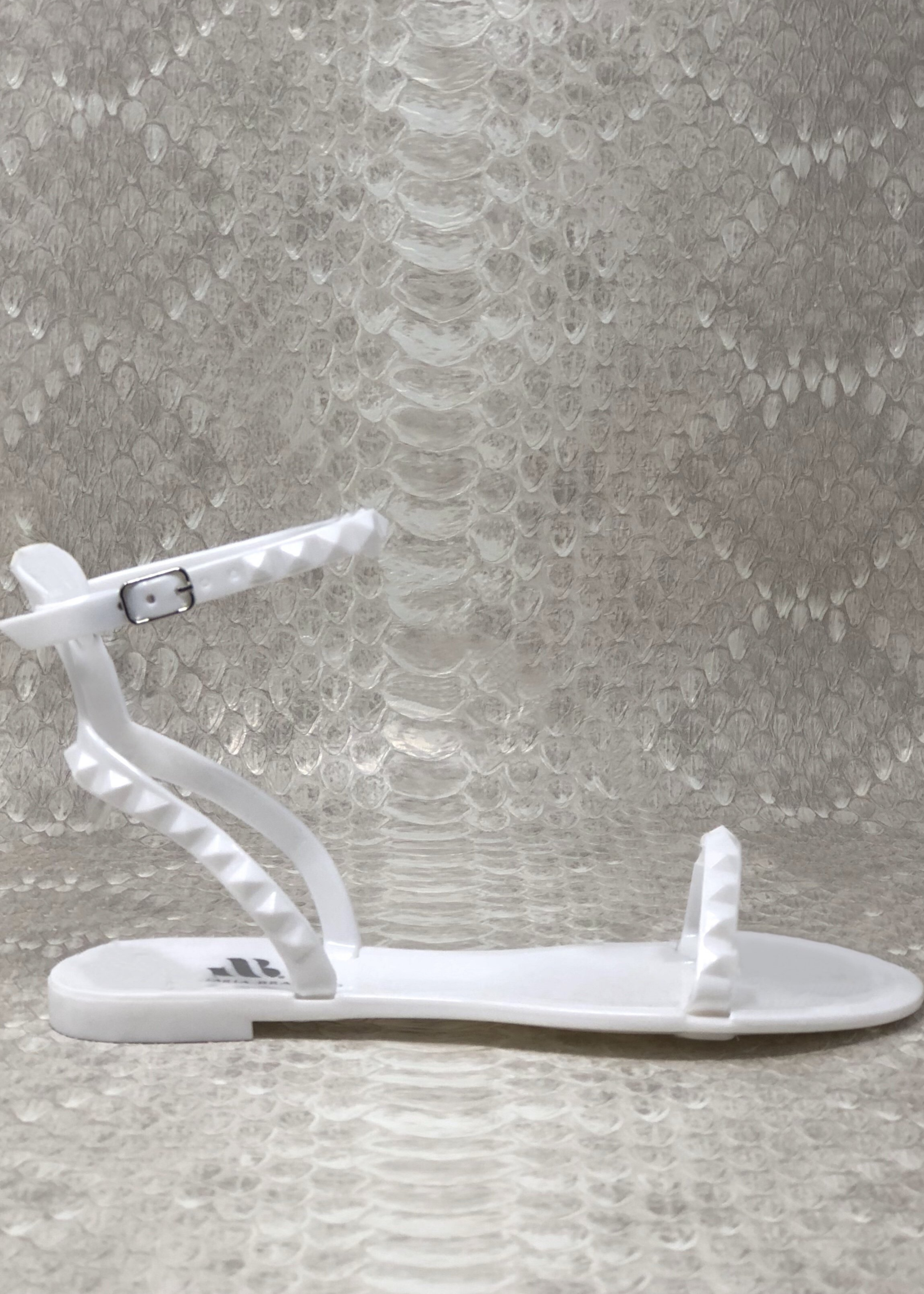 Aria in White jelluy sandals. Side view