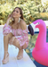Summer Must Haves - Alyssa Wedge in Nude. Nude suede ALYSSA wedge with crisscross strap that crosses in the back as the buckle buckles in the side that is silver. Thick to thin back to thick strap in the front. Model is modeling with a flamingo flootie next to the pool.