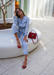 @carlanunez_ styled in a jean jumpsuit and accessorized with our Aria scarlet jelly sandals.