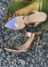 Audrey rose  gold slip-on heel with clear front strap.