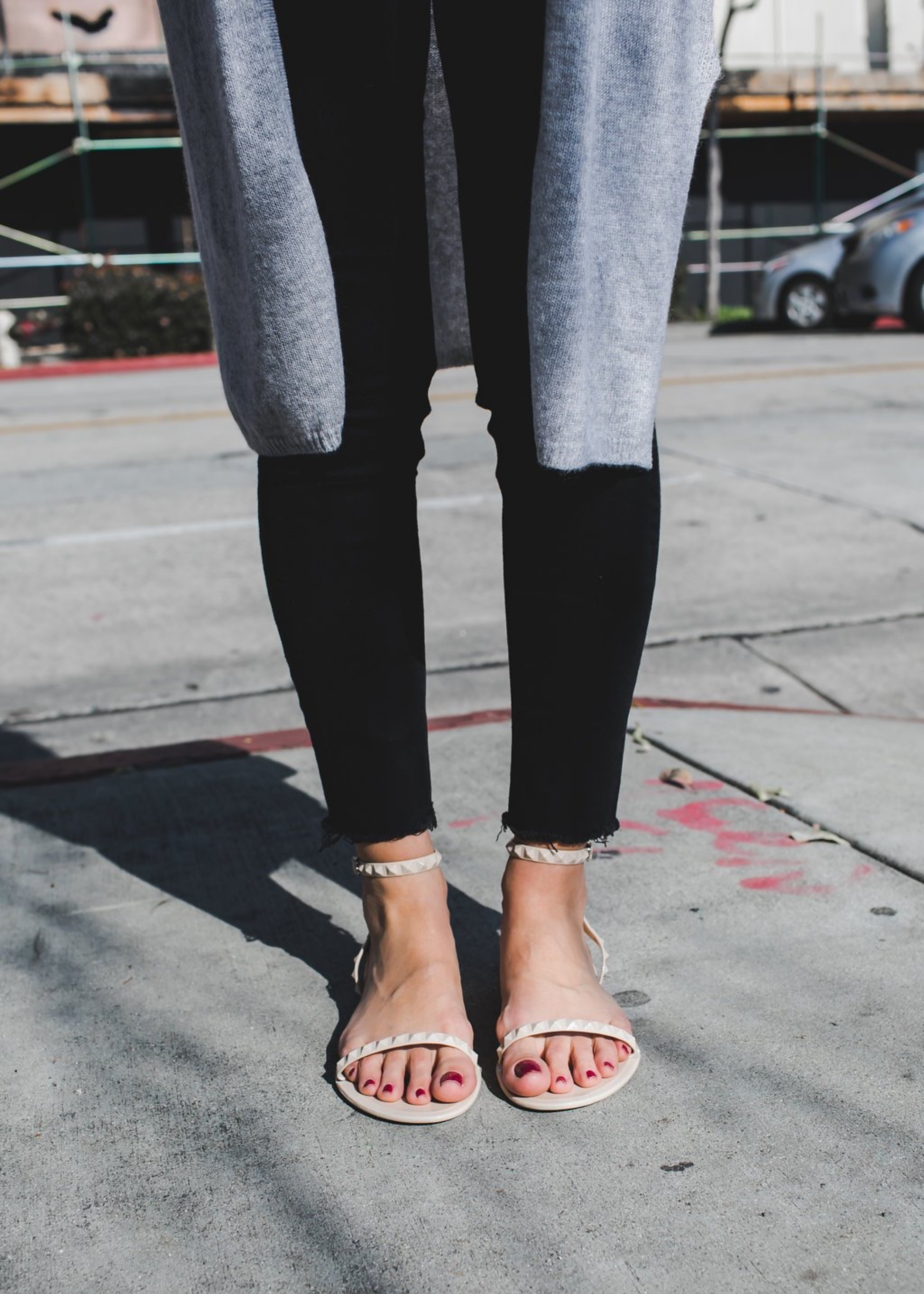 Close up of @karla_jordan3 wearing Aria sandals in Nude paired with black jeans. 