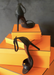 Our Black Ali sandal heels propped up on orange boxes.
