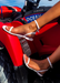 Aria white waterproof jelly sandals against a red ATV on the beach.