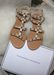 Ava sandals in Nude with Silver studded details on top of a plush fur pillow.