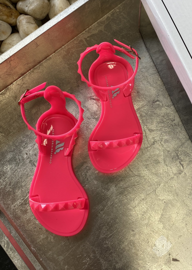 Little Girl's neon pink  sandals. kids aria sandals with sparkle gold sole and gold studded strap in the front and on in the back that buckles 