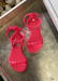 Little Girl's neon pink  sandals. kids aria sandals with sparkle gold sole and gold studded strap in the front and on in the back that buckles 