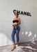 @gabiiiking via Instagram wearing Aria sandals in Black standing by the Chanel store.